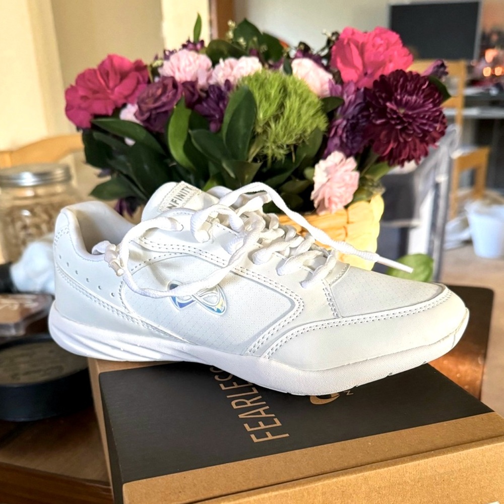 Nfinity size 5 adult white cheer shoe, new in original box. Never worn.